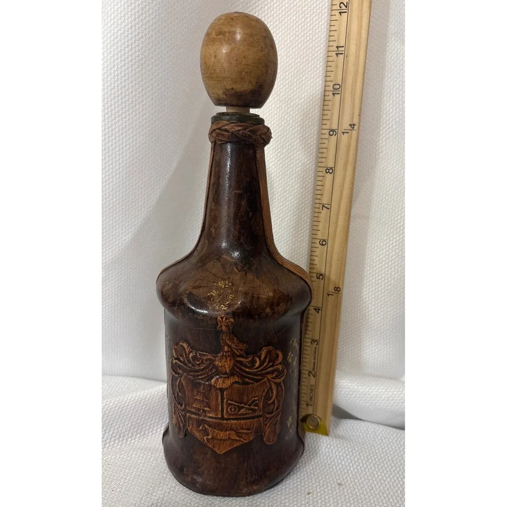 Vintage Leather Wrapped Decanter Bottle Embossed Coat of Arms Crest Wood Stopper